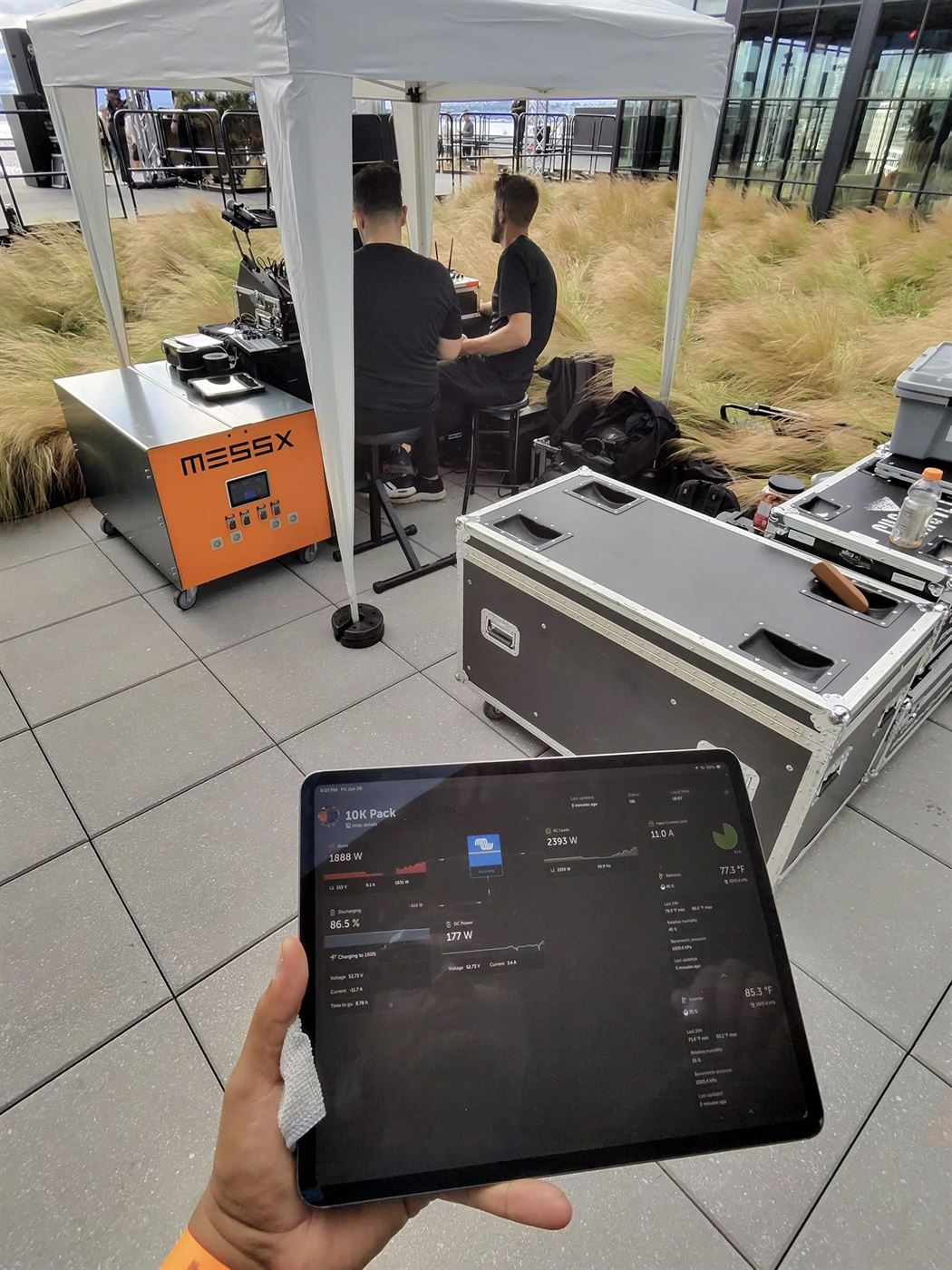 MESSX 10K powering a DJ booth at A Rooftop Named Desire in Seattle, with live system monitoring shown on a tablet